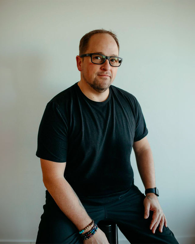 Rob Hanrieder, owner of Beyond Vinyasa smiling at the camera